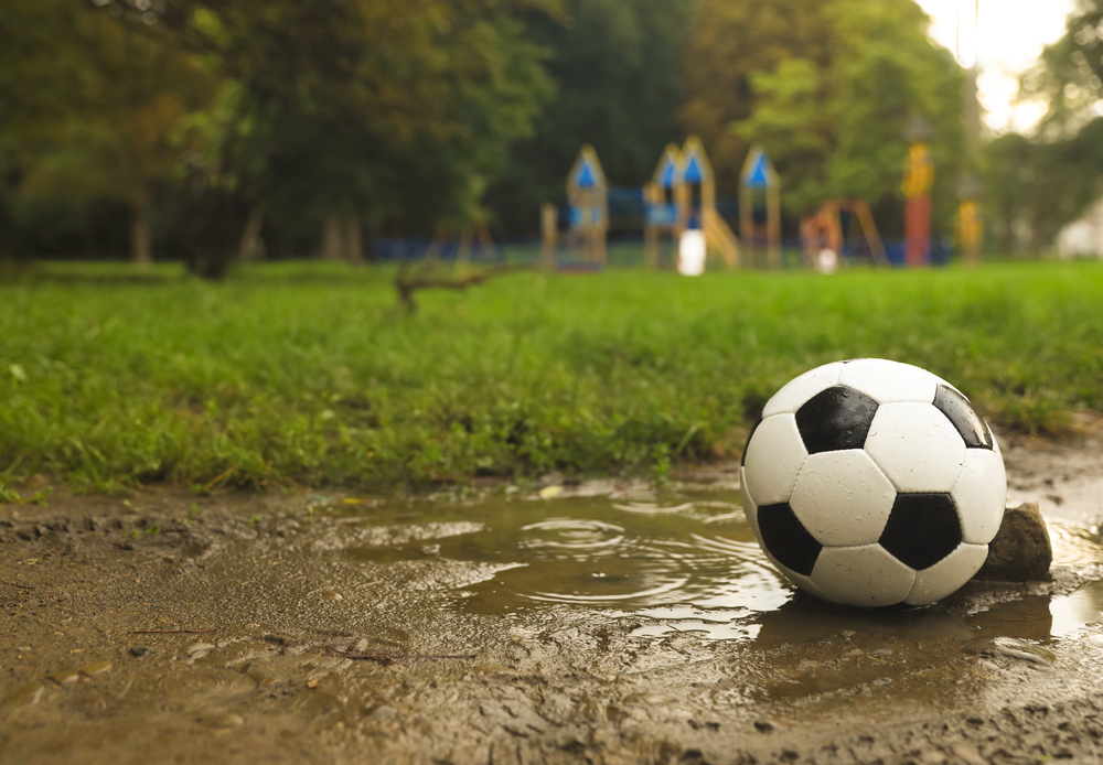 Soccer ball outside in the rain - Kids Outside Adventures