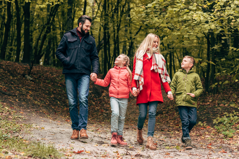 Family walking in the woods with coats and boots on - Teaching Kids to Appreciate Nature - Kids Outside Adventures
